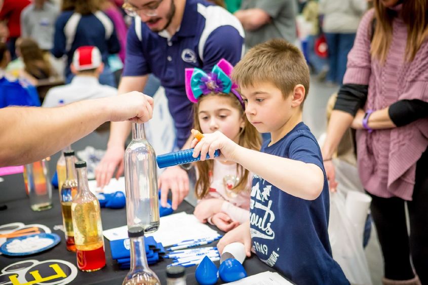 Two children play at a science table during the Penn State Behrend STEAM Fair in 2020.