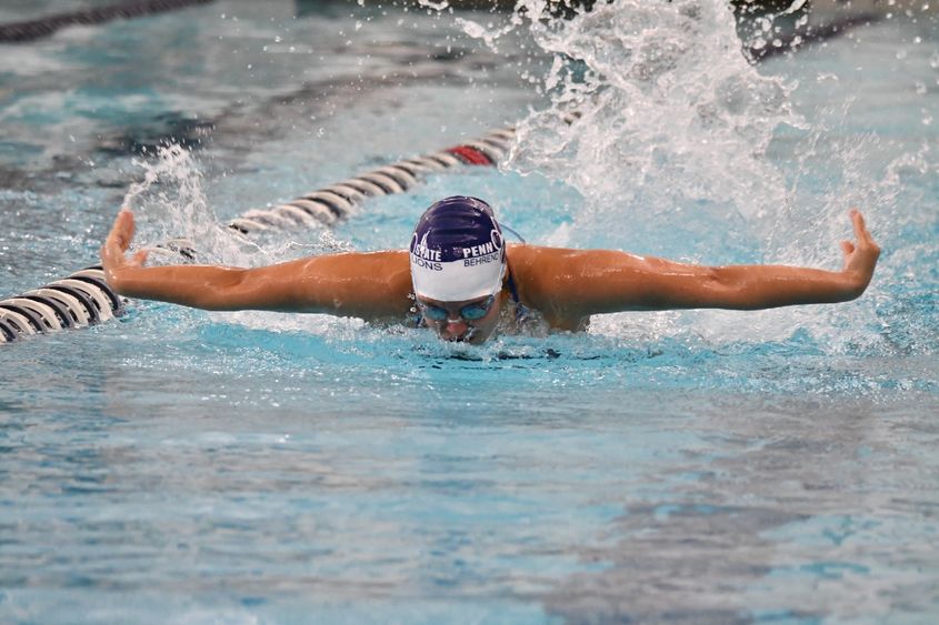 A female swimmer competes in a butterfly event.
