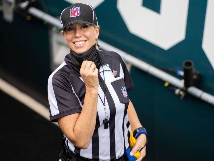 Sarah Thomas, the first female NFL official, on the field during a game.