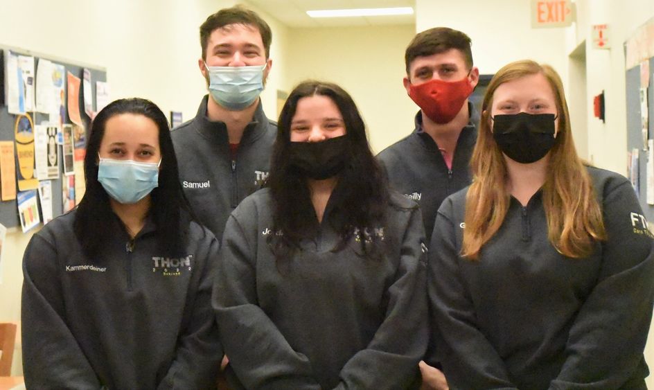 Five Penn State Behrend students pose in their THON sweaters.