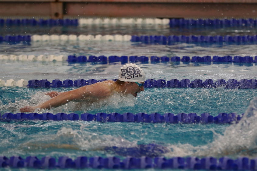 Penn State Behrend swimmer Tim Compton competes in a butterfly race.