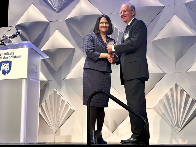 Penn State President Neeli Bendapudi presents the Alumni Fellow award to Thomas C. Hoffman II.