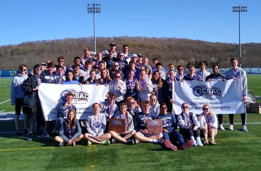 Penn State Behrend's track and field teams pose with the CSAC championship banners.