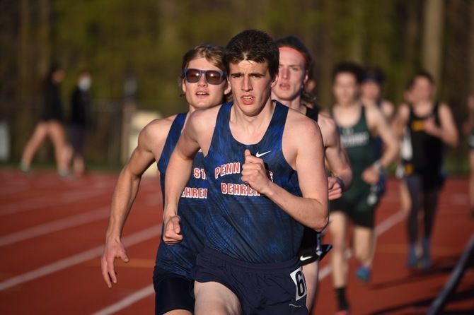 Two Penn State Behrend runners lead the pack in an outdoor track race.