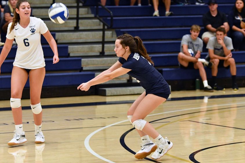A Penn State Behrend women's volleyball player hits a dig.