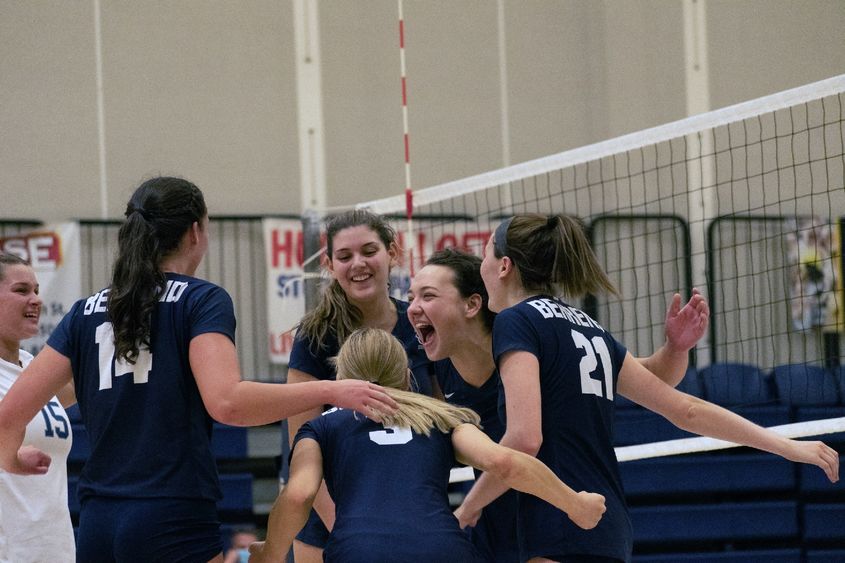 Members of the Penn State Behrend women's volleyball team celebrate a win.