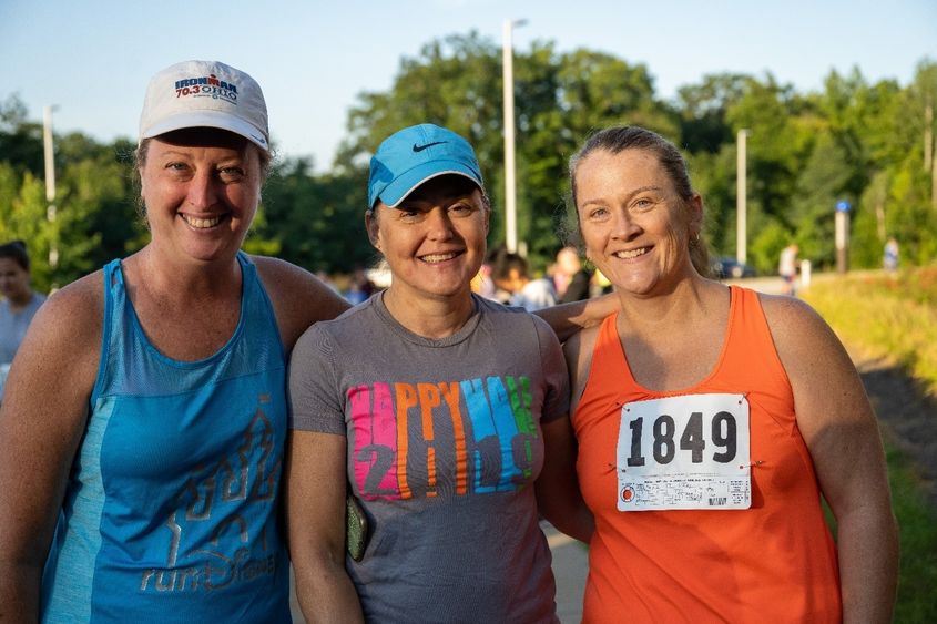 Three women pose at the finish line after the Women's Engagement Council's Run for Women at Penn State Behrend.