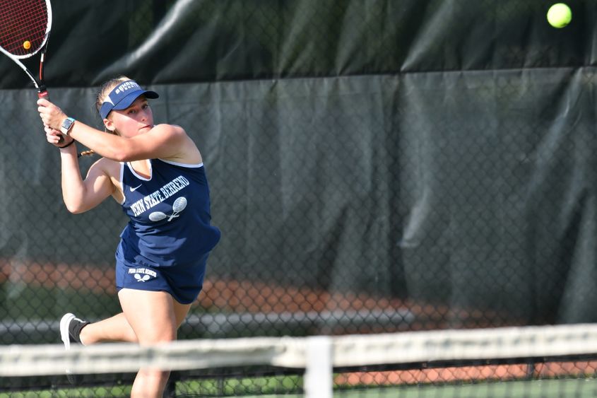 A Behrend tennis player hits the ball.