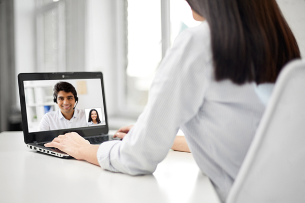 Female on computer talking to male on screen