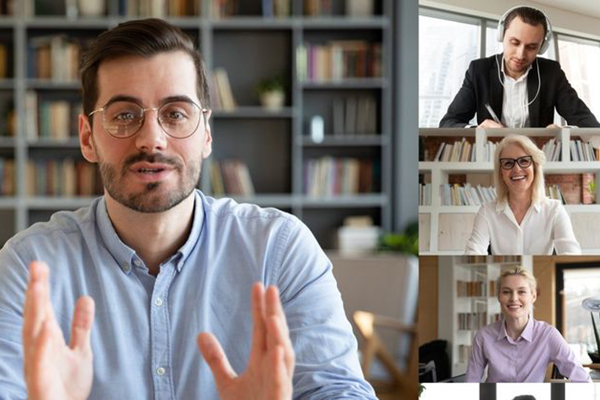 Male in blue shirt interviewing with three executives in smaller windows