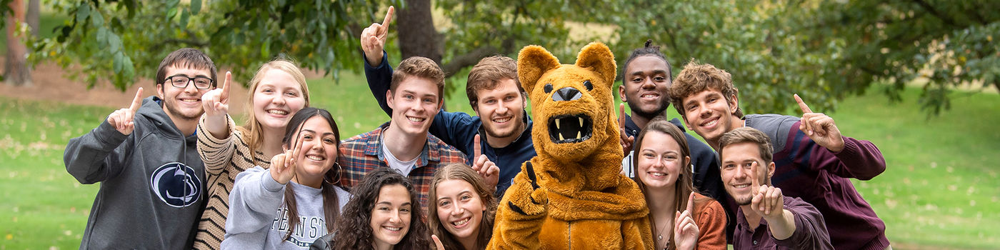 A group of Behrend students posing with the lion mascot