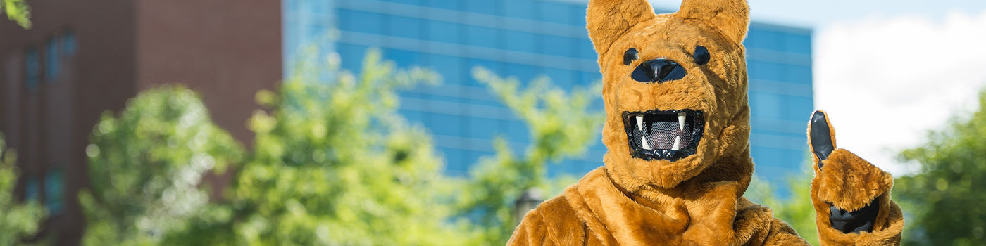 Lion mascot standing outside Burke Center