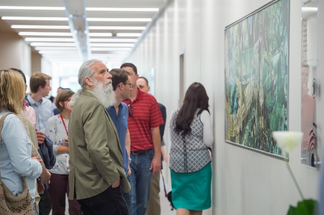 Visitors look at the art in Penn State Behrend's new AMIC building.