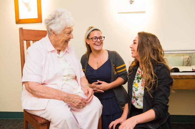 Patricia S. Yahn talks with students in the Lilley Library gallery space.