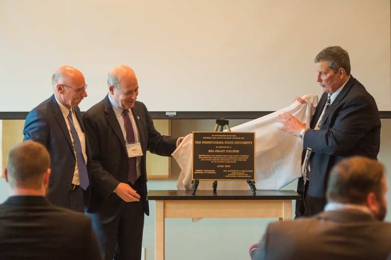A plaque conferring college status is unveiled at Pennsylvania Sea Grant.