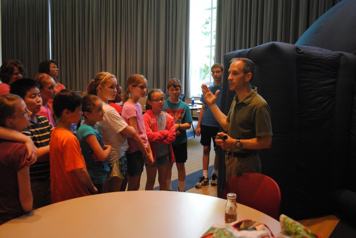 The Yahn Planetarium's shows can go on the road thanks to the portable planetarium, shown here with students from St. George School.