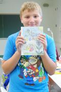 David Showers, 10, holds the book he wrote at College for Kids.