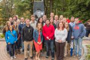 Students and alumni pose at the Mary Behrend monument