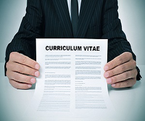 Image of a person in a suit holding a paper labeled Curriculum Vitae