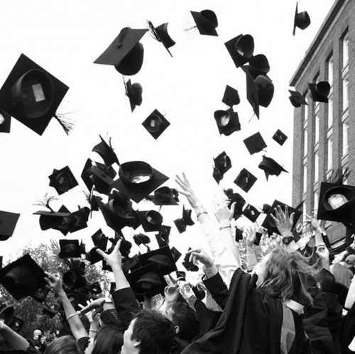 Image of a group of graduates tossing their hats in the air
