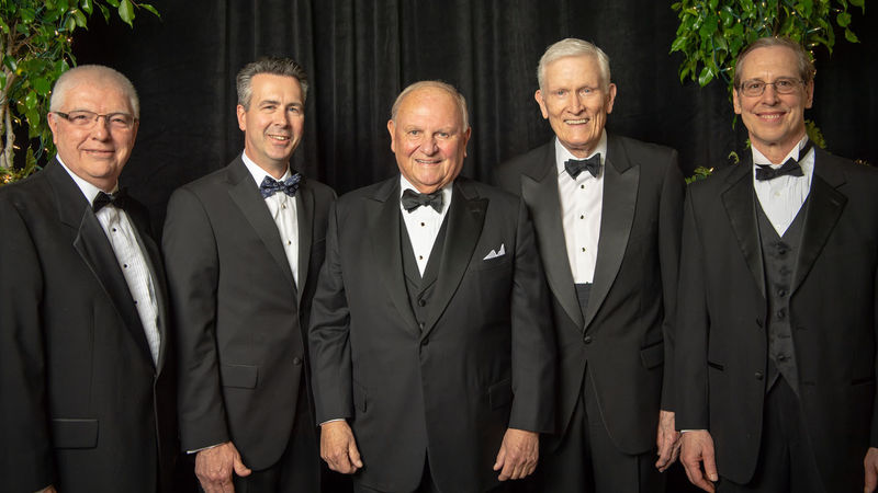 Four former and present Penn State Behrend leaders pose with Thomas B. Hagen